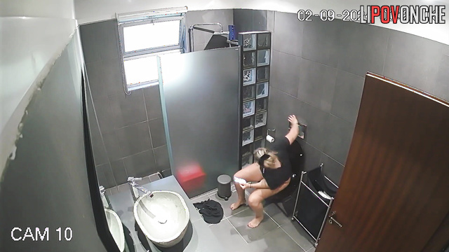 Blonde takes off her shorts completely so she can sit more comfortably on the toilet