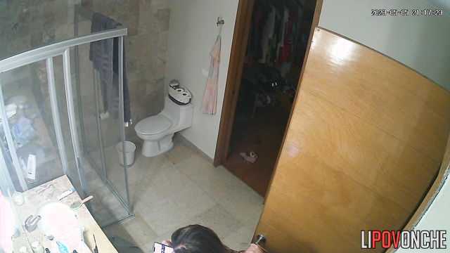 A sexy mommy seductively slips her jumpsuit off her chic body to sit on the toilet