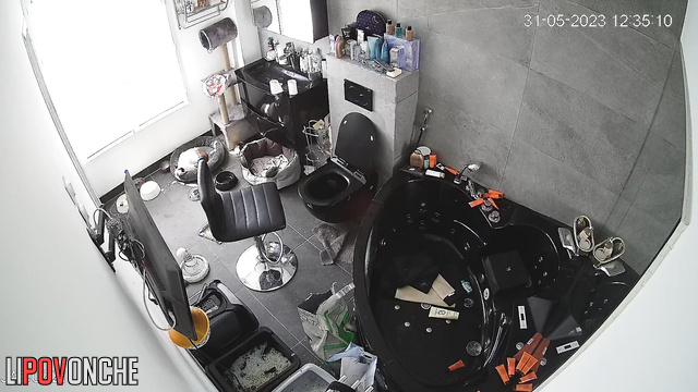 A pretty mommy with a voluptuous naked body is fixing her hair in front of the mirror