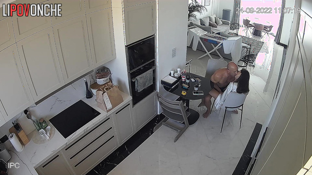 A bald man is vigorously fucking his wife right on the chair