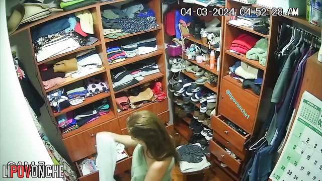 A seductive mommy completely strips down in the locker room, unaware of the camera