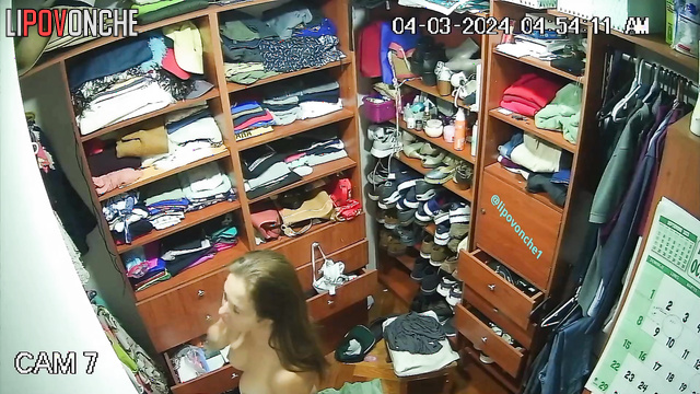 A seductive mommy completely strips down in the locker room, unaware of the camera