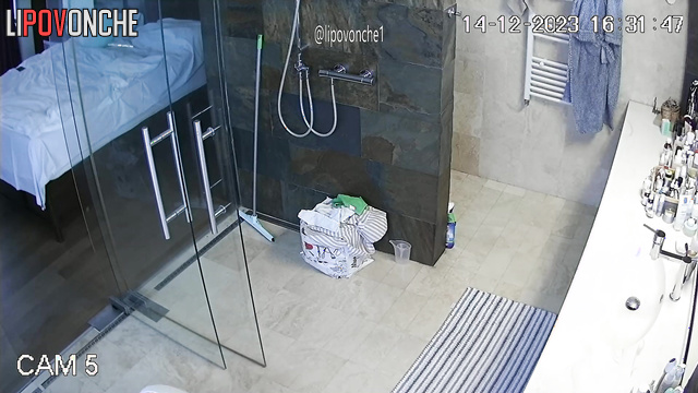 A seductive milf with big nipples does a little cleaning topless