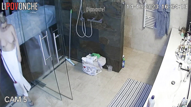 A seductive milf with big nipples does a little cleaning topless