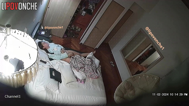 Brunette pleasures herself on the bed in the bedroom with a vibrator