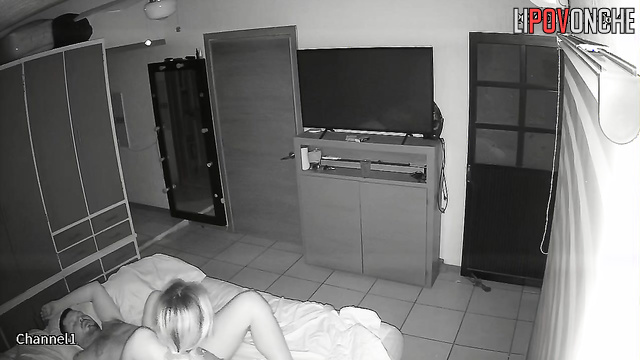 An aroused husband tries to pull the nightgown off his sleeping wife