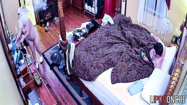 A tattooed cutie with a bare bottom is lying there watching TikTok with her husband