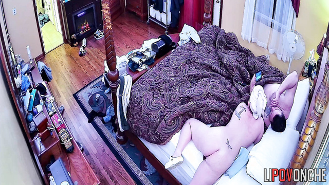 A tattooed cutie with a bare bottom is lying there watching TikTok with her husband