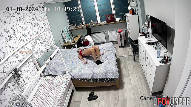 A long-haired housewife in sexy panties works out right on the bed