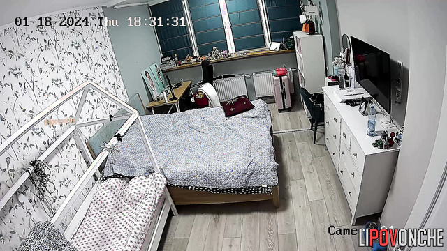 A long-haired housewife in sexy panties works out right on the bed