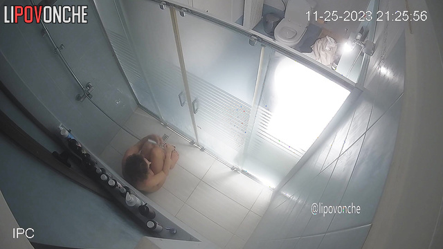 A completely naked, seductive beauty prefers to shower while sitting down