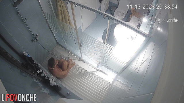 A husband secretly filmed his wife looking at her breasts and taking a shower