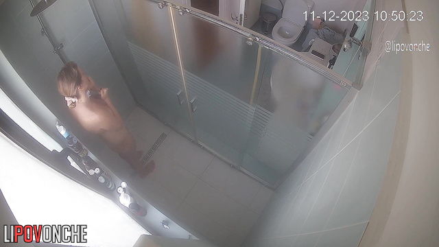The beauty seductively slips out of her robe and takes a shower