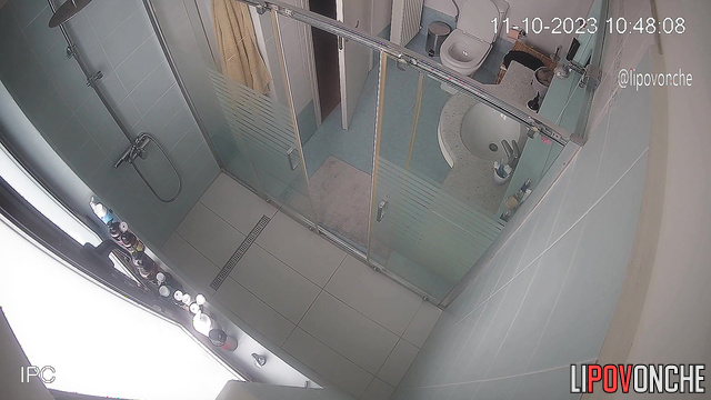 A charming mommy seductively strokes her tits while taking a shower