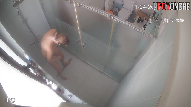 A slim cutie carefully examines her shaved pussy before heading into the shower