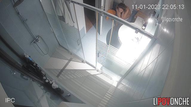 A sleepy woman, completely naked, walks into the toilet