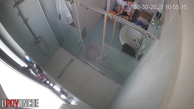A slender mommy undresses while sitting right on the toilet