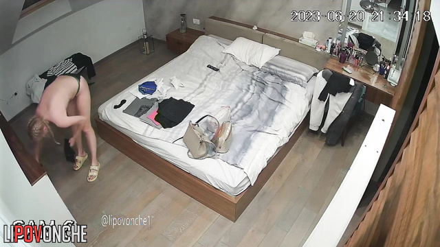 A skinny blonde with very small tits tidies up the bedroom wearing nothing but panties