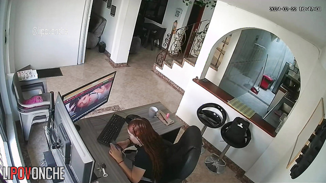 A bored redhead is browsing a porn chat room featuring seductive naked girls