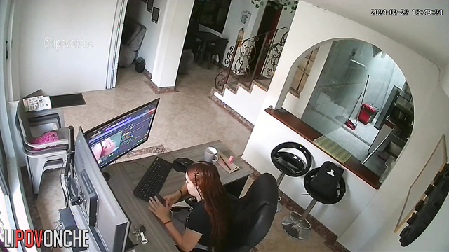 A bored redhead is browsing a porn chat room featuring seductive naked girls