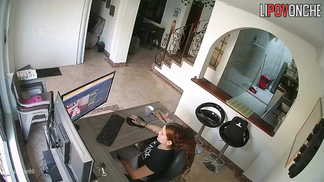 A bored redhead is browsing a porn chat room featuring seductive naked girls