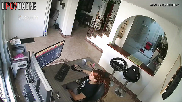 A bored redhead is browsing a porn chat room featuring seductive naked girls