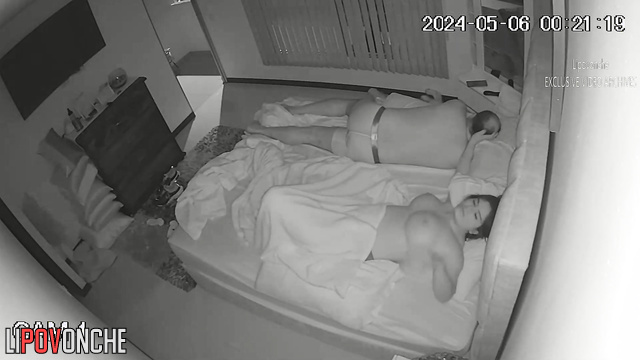 A busty girl plays with her hot pussy while her balding husband sleeps