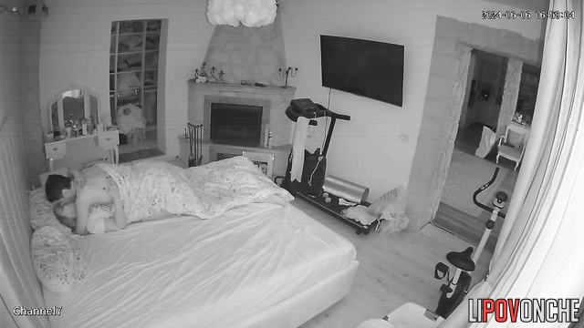 The husband playfully nibbles his wife's soft buttocks as he pulls down her panties