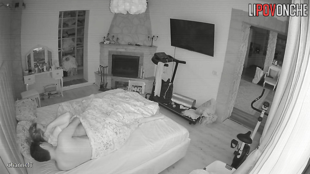 The husband playfully nibbles his wife's soft buttocks as he pulls down her panties