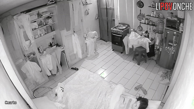 A bored brunette strokes her clitoris under the covers while watching porn