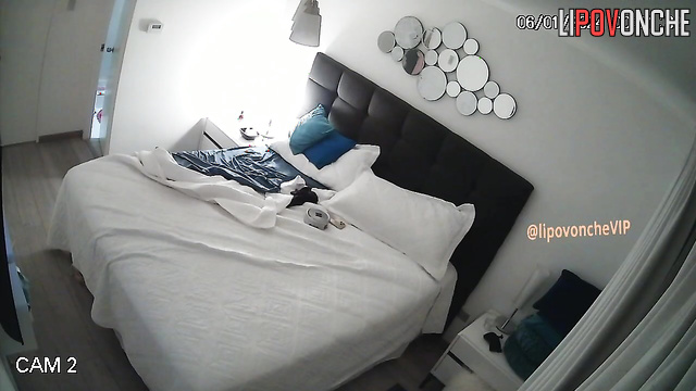 A glamorous prostitute relaxes and smokes in bed after seeing a client