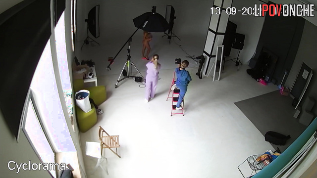 A hidden camera captured a photo shoot of a half-naked pregnant beauty