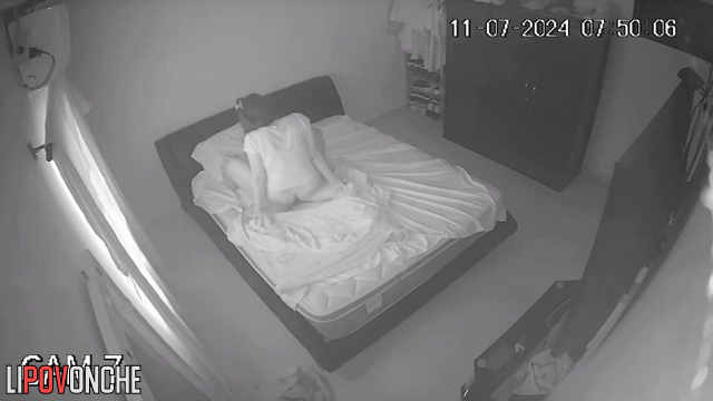 An aroused husband tries to press his cock against his sleeping wife's ass