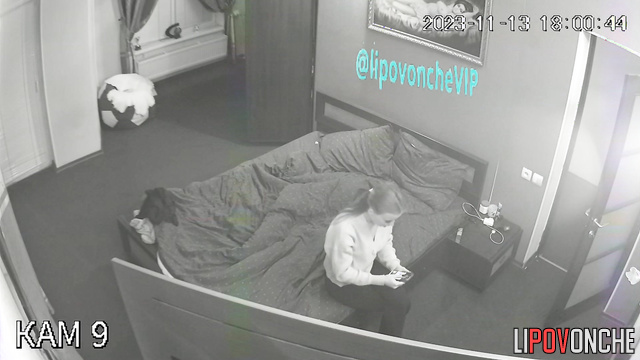 Slender brunette walks around room topless, trying on clothes and singing