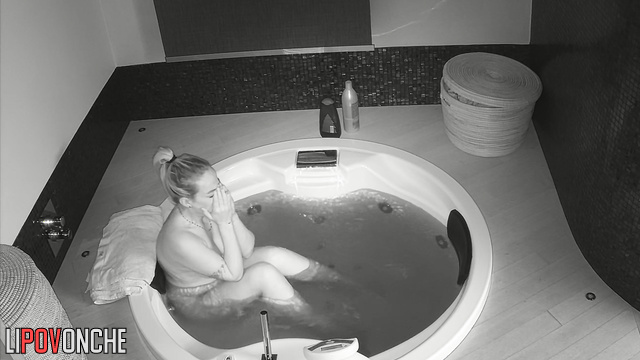 Busty blonde relaxes in hot jacuzzi and thinks about having sex later