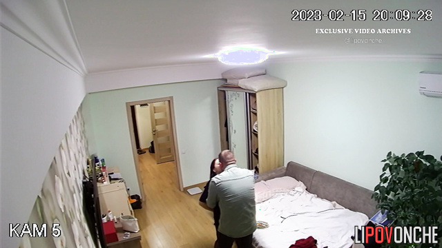 Long-haired brunette kissing her husband after work