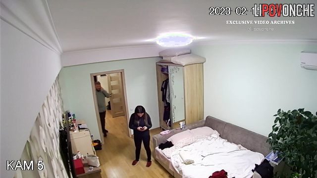 Long-haired brunette kissing her husband after work