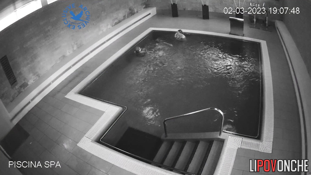 Two chubby ladies chatting in the pool without bra